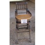 A 19th century oak framed child's high chair with metal wheels and fittings est: £30-£50