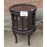 A 20th century mahogany cylindrical glazed drinks cabinet with detachable butler's tray to top est: