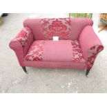 An early 20th century drop end two seater sofa upholstered in deep red material est: £100-£150