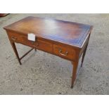 A pretty Edwardian inlaid writing table with an inset tooled tan leather top over three drawers and