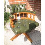A late 20th century swivel Captain's desk chair upholstered in deep buttoned green leather est: