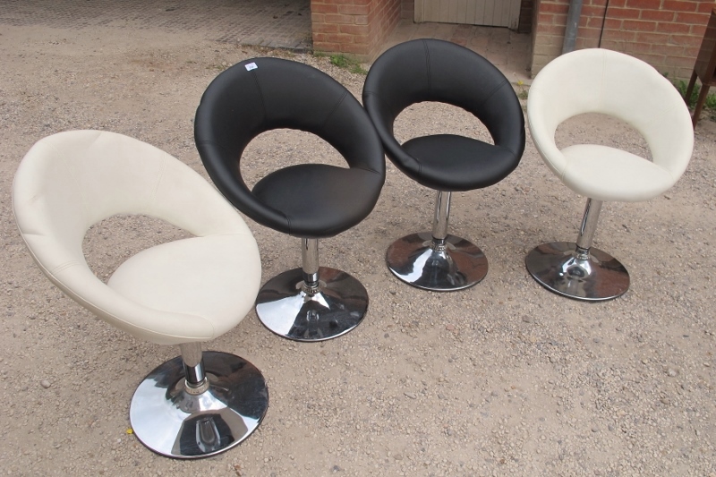 A set of four retro design late 20th century swivel chairs,