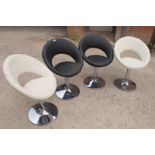 A set of four retro design late 20th century swivel chairs,