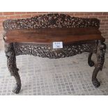 A 19th century Burmese carved consul table with fret work design over birds and animal heads est: