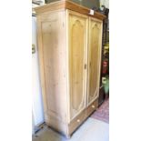 A 20th century pine double wardrobe with interior hanging space over two drawers to base est: