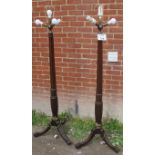 A fine pair of mahogany standard lamps each with reeded columns and brass three branch light