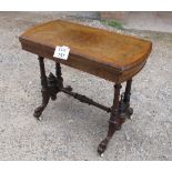 A fine burr walnut turn over card table with cross banded top over carved legs and white casters