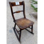 A 19th century oak rocking chair with turned supports est: £20-£40