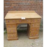 A Victorian pine desk with a rear gallery rail over nine drawers to base and with glass handles