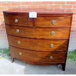 A George III mahogany bow front chest of two short over three long drawers with brass ring handles