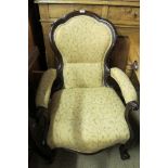A Victorian gentleman's lounge armchair upholstered in cream floral material and in good condition