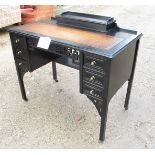 A black lacquered oriental desk with fitted stationery box to top and a tan leather over six