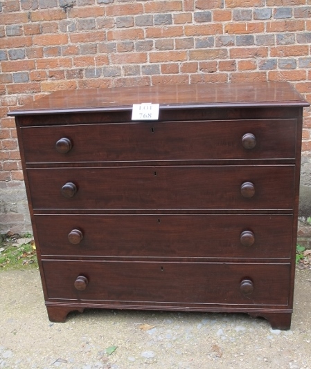 A 19th century mahogany chest of four long drawers with bun handles and terminating on bracket feet