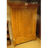 A 19th century pitch pine wardrobe with double cupboard doors flanked either side by reed columns