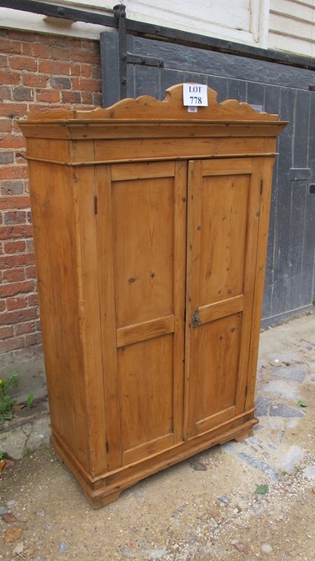 A 19th century pine single wardrobe of small proportions with double panelled doors revealing