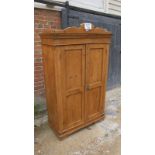 A 19th century pine single wardrobe of small proportions with double panelled doors revealing