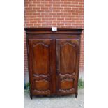 A 19th century French solid oak armoire wardrobe with carved panelled doors revealing interior