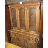 A good quality 20c oak dresser with triple glazed doors revealing adjustable shelves over three
