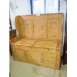 A large 20th century pine settle/hall seat with lift up seats revealing a large storage area to