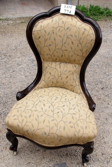 A Victorian ladies nursing chair upholstered in cream floral material (matches previous lot)