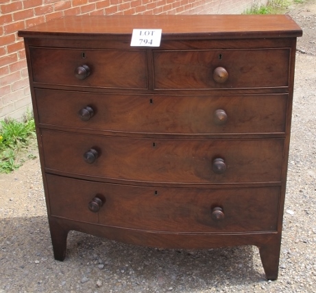 A Victorian mahogany bow front chest of two short over three long drawers with turned handles est: