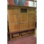 A large Bespoke solid oak kitchen cupboard with centre shelves above pull out wicker baskets to