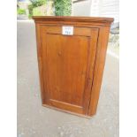 A 19th century pine corner wall cupboard with three fitted shelves and a large panelled door est: