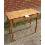 A 20th century pine side table with single drawer with glass handles over turned legs est: £30-£50