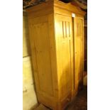 A continental pine wardrobe with double panelled doors over two drawers to base est: £100-£150