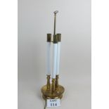 A brass table lamp with three columns es