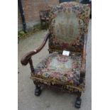 A large 19th century carved mahogany framed armchair upholstered in tapestry material in need of