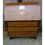 A late 19th century mahogany bureau with fitted interior over three drawers and with shell inlay