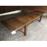 A 19th century oak refectory dining table with two additional leaves and with centre stretcher est: