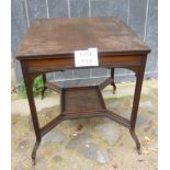 An Edwardian mahogany side table by James Shoolbred & Co with reeded edges and terminating on