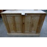 A 20th century pine two door sideboard with interior shelves est: £60-£90