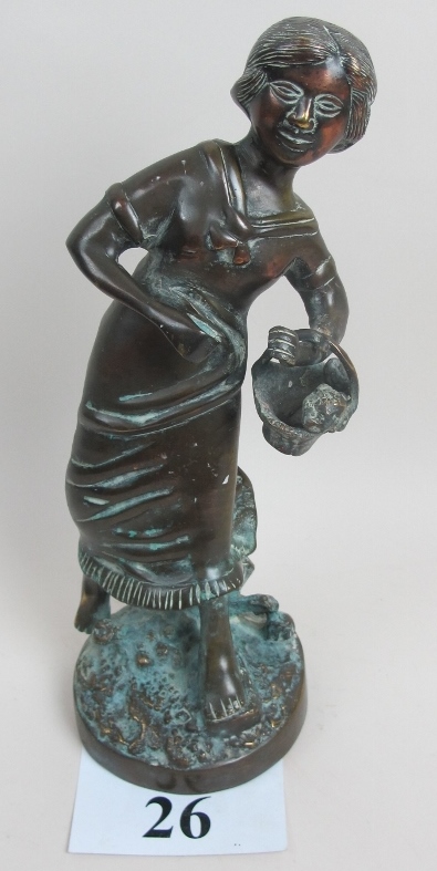 A bronze figurine of a young woman with