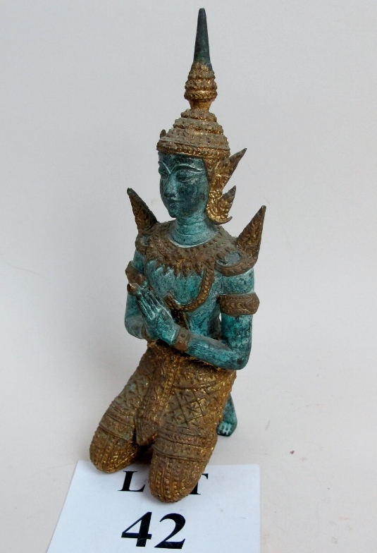 A painted metal figurine of an oriental