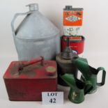 A vintage petrol can, two graduated oil cans, Esso, Vigzol and Cow & Gate advertising-ware tins,