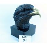 A modern bronzed model of an Eagle's head, plinth base,