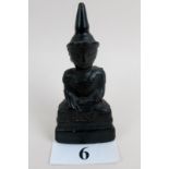 An antique Asian lacquered wooden figure depicting a seated Buddha, some lacquer missing,