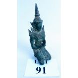 An antique Chinese bronze figure of a kneeling Buddha praying, 18 cm high,