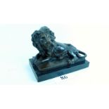 A modern bronzed model of a recumbent lion, on a plinth base,
