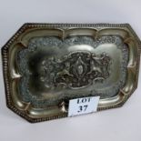 A 19th century silver plated tray/plaque, embossed with lions with flags amidst scrolls and foliage,