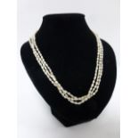 A three strand freshwater pearl necklace with 9ct gold clasp, 17.5" in length.