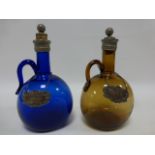 Two coloured glass decanters with silver Whisky and Brandy decanter labels hallmarked 1969 and 1970.