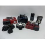 Collection of film and digital cameras including a Canon T70 with 35-70mm f3/5-4/5 lens,