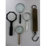 Four assorted large magnifying glasses and a Salter pocket balance scale 112 LB.