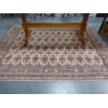 Boukhara rug with four row of eleven guls, on pink ground, 232x171cms.