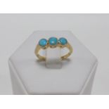 18ct gold ring set with three Turquoise stones, size N.