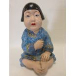 Large pottery figure of a seated Japanese girl in a traditional blue robe, 40cm high.